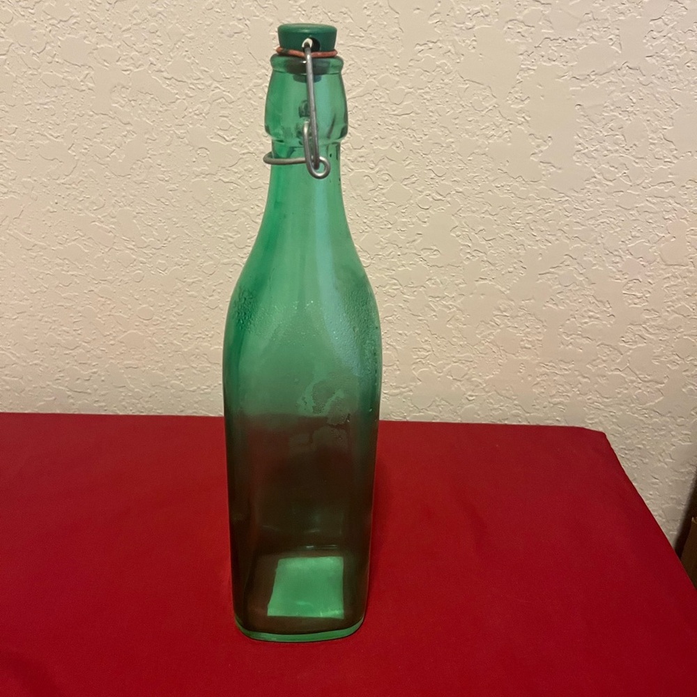 Tall green glass bottle